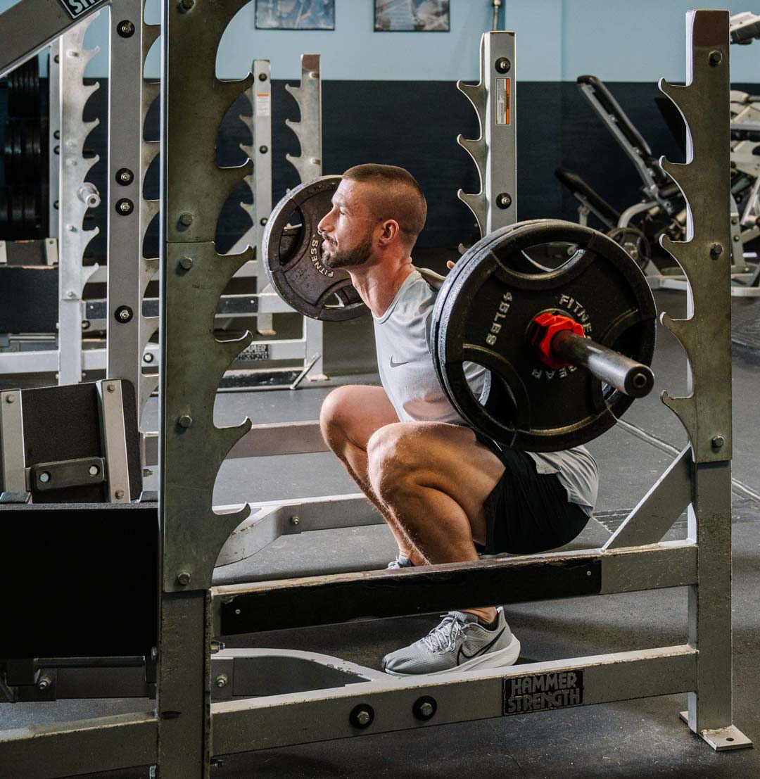Guy performing a squat with perfect form.